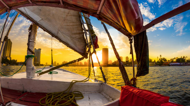 Felucca ride on the Nile Felucca ride on the Nile at sunset, Cairo, Egypt felucca boat stock pictures, royalty-free photos & images