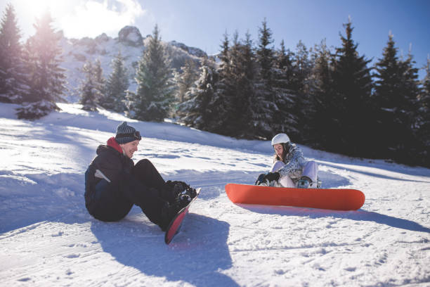 istock Sitting Down In Snow, Enjoying Lazy Break On Snowboarding Holiday 916255716