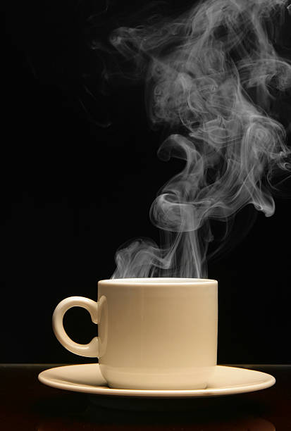 istock Hot drink in a cup and saucer steaming on a black background 91625974