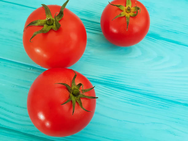 istock ripe red tomatoes on blue wooden 916262658