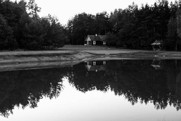 A small house refleced in a lake