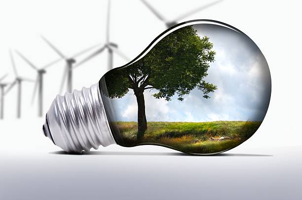 Environmental graphic with turbines and light bulb stock photo