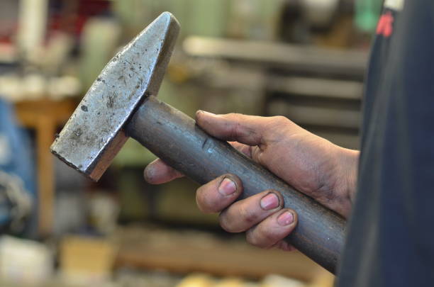 istock A dirty hand holds a hammer 916263820