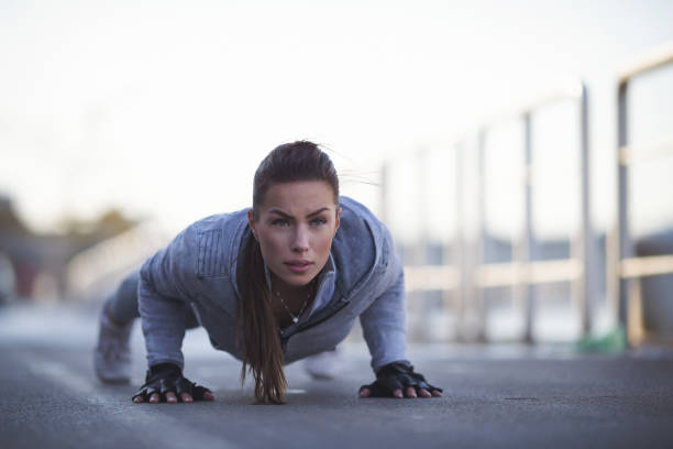istock Beautiful young woman doing pushups 916269688