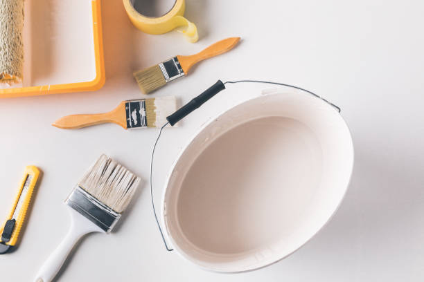 istock top view of bucket with white paint and tools for repairs on surface 916271648