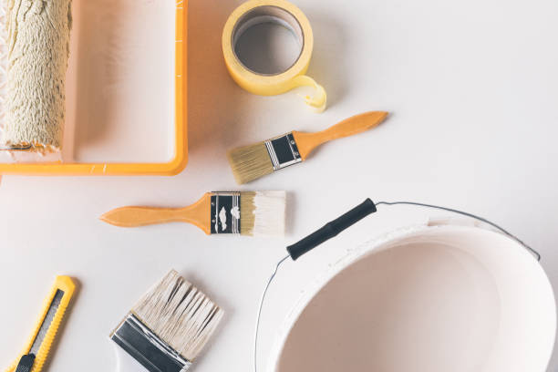 istock top view of bucket with white paint and different tools for repairs on surface 916271842