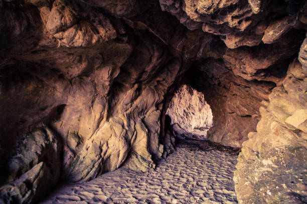 Looking through a beach cave at sunset, Leo Carillo State Beach, California