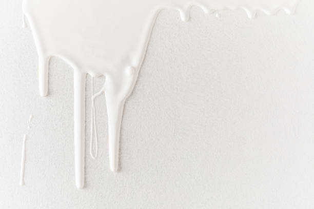 white dripping paint on white surface - paint drops imagens e fotografias de stock