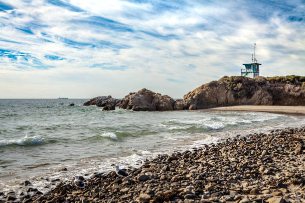 Leo Carrillo State Beach at high tide on a partially cloudy day.