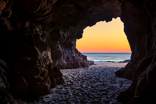 Looking out from a beach cave at sunset in the intertidal zone of Leo Carillo State Beach, California.