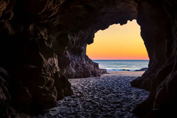 Photo of Looking out of a beach cave at sunset, Leo Carillo State Beach, California
