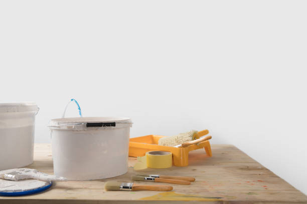 istock buckets with paints and plastic tray on wooden table 916278292