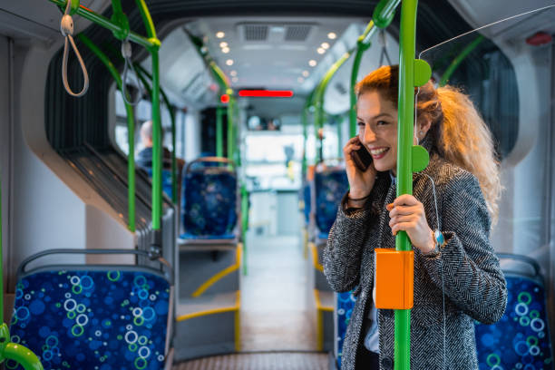 istock Woman using phone and driving on the bus 916280676