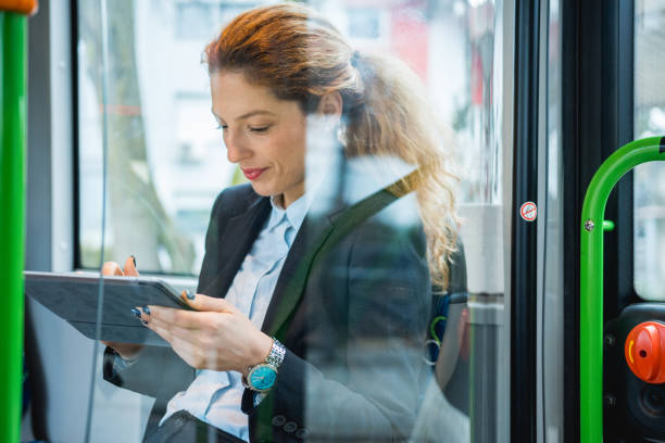 istock Businesswoman using digital tablet on the bus 916280690