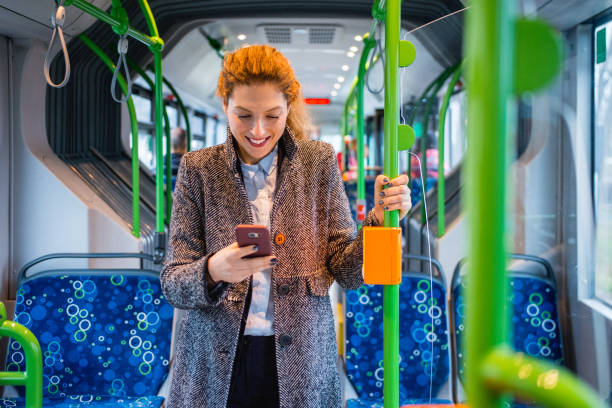 istock Woman using phone and driving on the bus 916280694