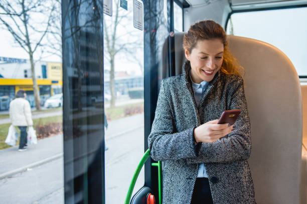 istock Woman using her smart phone on the bus 916280700