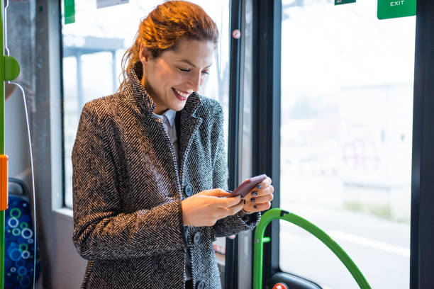 istock Woman using phone and driving on the bus 916280716