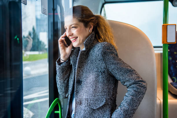 istock Woman talking on the smart phone on the bus 916280718