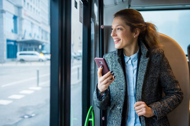 istock Businesswoman using smart phone on the bus 916280722