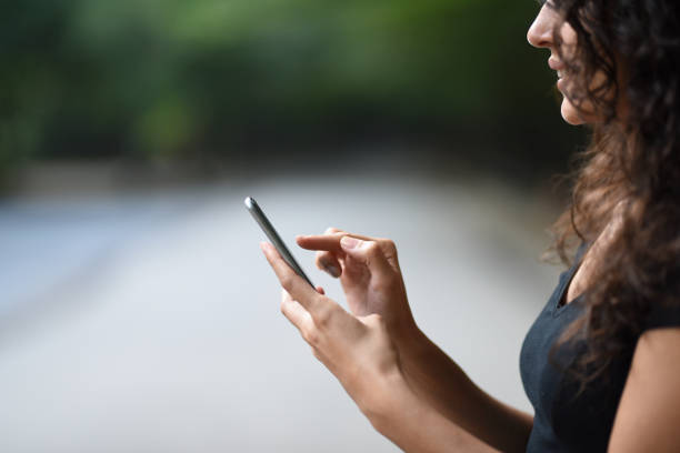 istock Young woman is using mobile phone, close-up 916281382