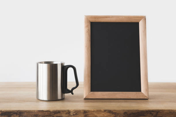 istock silver cup and blackboard in frame on wooden table on white 916285062