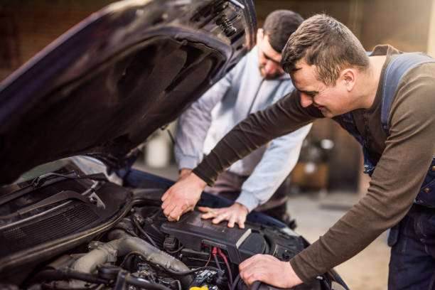 istock Two mechanics fixing a car together. 916285324