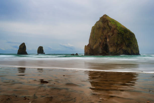 istock Cannon Beach Haystack Rock and Needles under cloudy skies 916285942