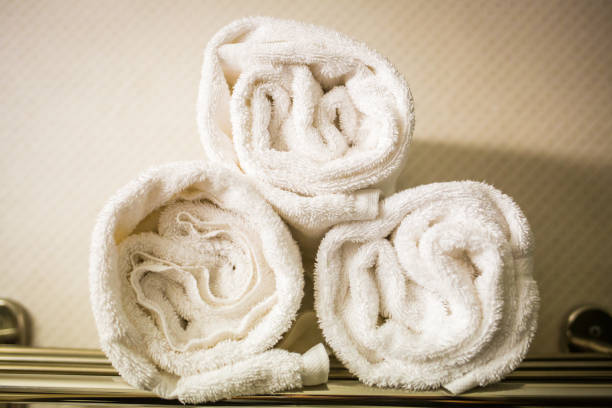 istock Rolled white towels on a shelf 916287602