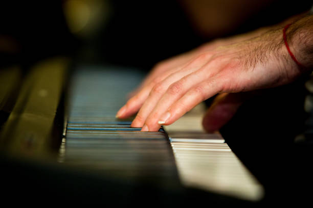 istock Close up male hands playing electric piano 916287696