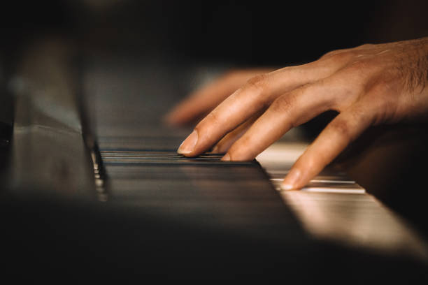istock Close up male hands playing electric piano 916287812