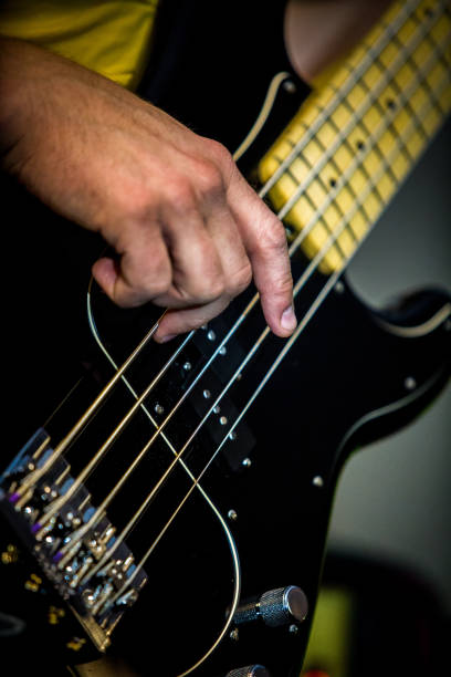 istock Bass guitar musician playing close up 916287878