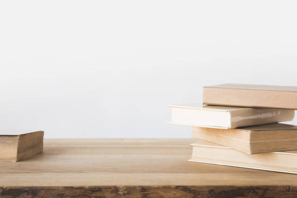 istock stack of old books on wooden table on white 916288424
