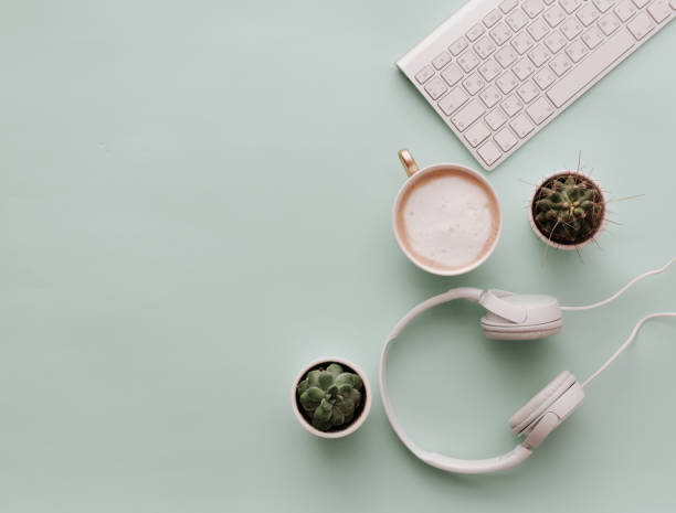 istock Home Office Desktop with headphones, coffee and keyboard. Minimalist Flat Lay Hipster Desktop 916288566