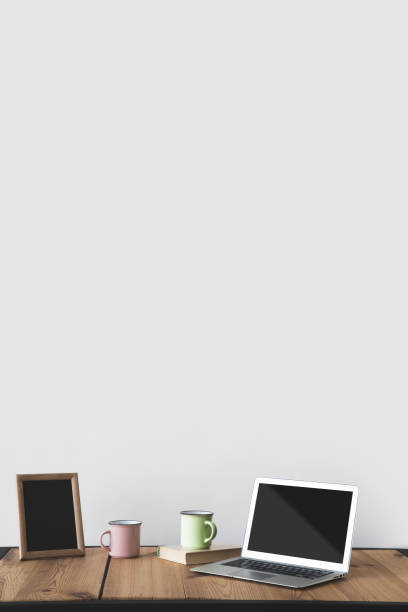 istock empty blackboard in frame with cups and laptop on white 916288824