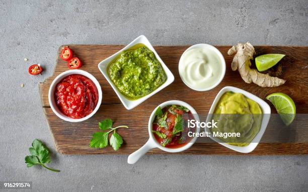 Various Dip Sauces On Grey Table Stock Photo - Download Image Now - Dipping Sauce, Salsa Sauce, Condiment