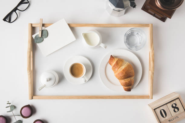 istock flat lay with cup coffee and croissant for breakfast on tray on white tabletop 916294526
