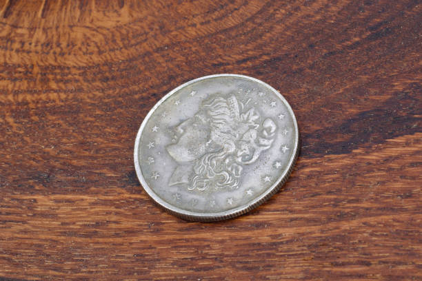 istock old vintage silver dollar on wooden background 916300758