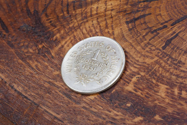 istock old vintage silver dollar on wooden background 916300862