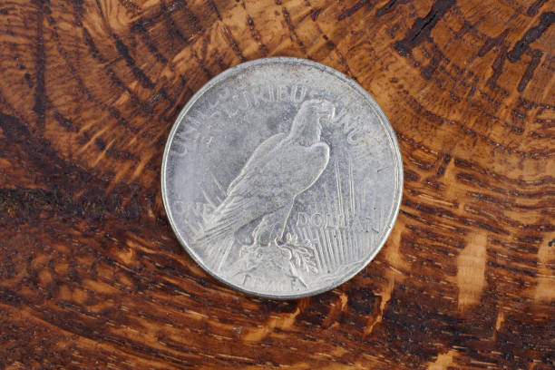 istock old vintage silver dollar on wooden background 916300910