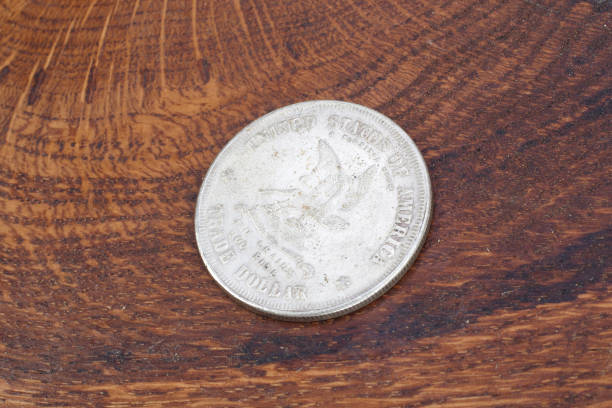 istock old vintage silver dollar on wooden background 916300934