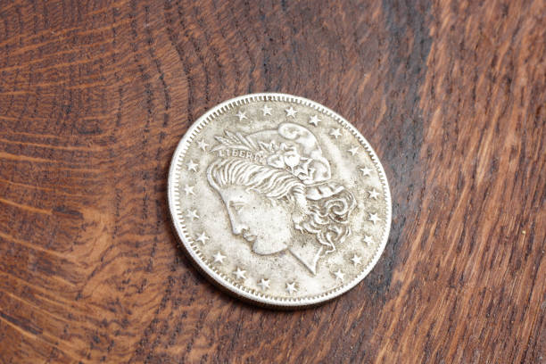 istock old vintage silver dollar on wooden background 916301030