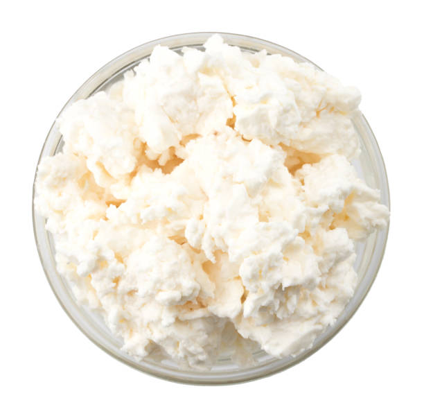 istock Cottage cheese in glass bowl on a white background, top view 916301034