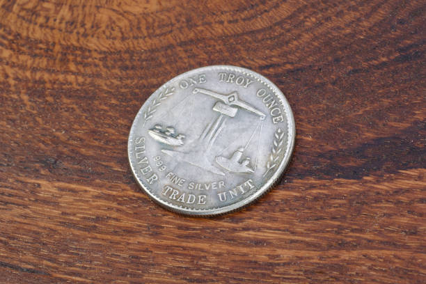 istock old vintage silver dollar on wooden background 916301140