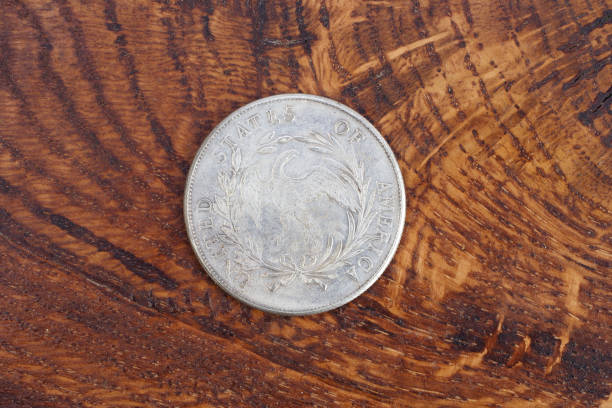 istock old vintage silver dollar on wooden background 916301184