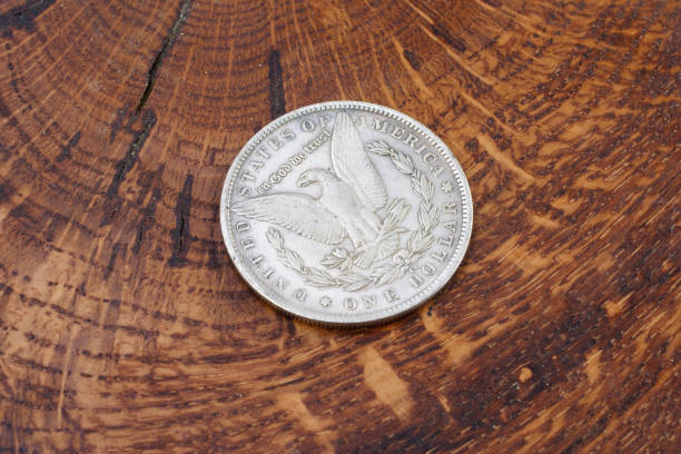 istock old vintage silver dollar on wooden background 916301214