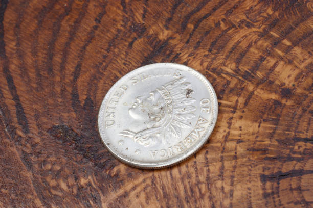 istock old vintage silver dollar on wooden background 916301240
