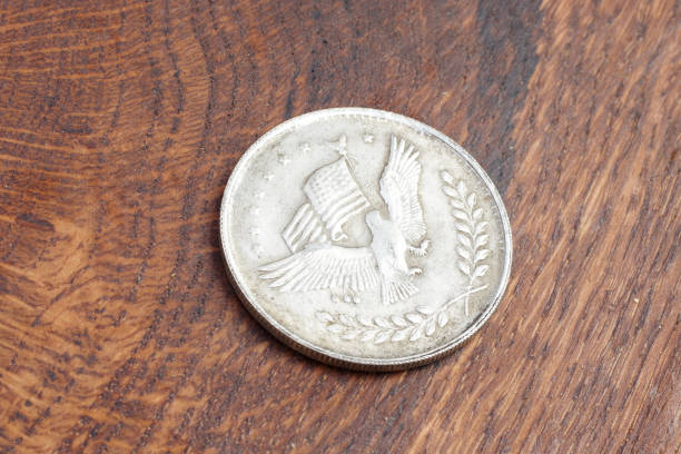 istock old vintage silver dollar on wooden background 916301276
