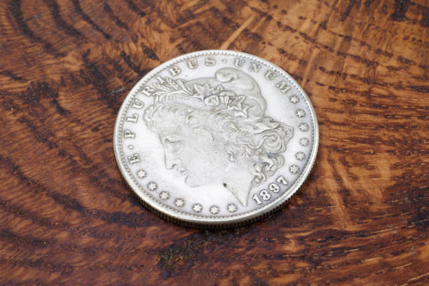 istock old vintage silver dollar on wooden background 916303524