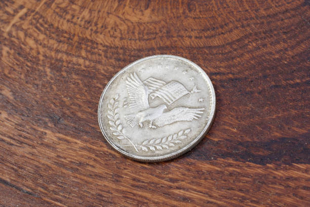 istock old vintage silver dollar on wooden background 916303568