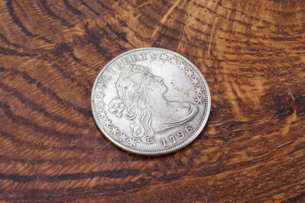 istock old vintage silver dollar on wooden background 916303710